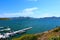 Boats in the harbor of Diamond Valley lake with deep blue lake water, blue skies and mountain ranges