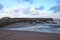 Boats in the harbour at Minehead in Somerset. The tide is out and the sky is stormy