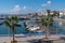 Boats in harbour with palm trees in October sunshine port of L`Ampolla, Catalonia, Tarragona Province Spain