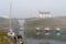 Boats in heavy sea fret at the harbour, at high tide in Seaton Sluice, Northumberland, UK