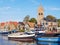 Boats, houses and church tower in town of Grou, Friesland, Netherlands