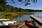 Boats and kayaks on shore by a lake