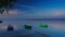 Boats on the lake during a bright, saturated sunset.