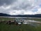 Boats on the lake. Tranquil nature view with gloomy sky and cloud reflections on the water