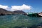 Boats laying at anchor in Hout bay with mountains and clouds in the background