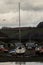 Boats left sitting on river bed as tide goes out next to Looe Bridge.