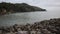 boats lined up at the mouth of the river. view of the river estuary near the beach. mountains background. murky water.