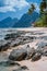 Boats in low tide under palm trees with amazing nature scenery rocky defocused foreground. Tropical travel landscape in