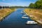 Boats moored on coast of river Vuka