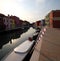 Boats moored in the navigable canal of Burano island near Venice