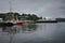 Boats moored in Oban harbor and a ferry leaving the harbor on a cloudy day, Scotland