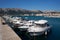 Boats moored in the port in the Croatian town of Baska on the island of Krk. In the background the old town and the promenade.