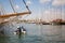 Boats moored in the port. Masts of ships against the sky.