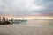 Boats moored to pier at sundown