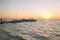 Boats moored to pier at sundown