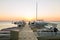 Boats moored to pier at sundown