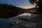 Boats moored to the shore of a night lake