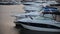 Boats moored on the water. Blue mediterranean sea water in marina port of Spain. Water alley between two rows of moored