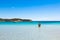 Boats mooring in the turquoise water of Rondinara beach in Cors