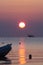 Boats in the morning time during beautiful romantic ocean sunrise at rimini beach italy