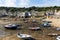 Boats in Mousehole harbour Cornwall England at low tide