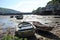 The boats on the mud beach with low tidal wave