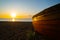 Boats and nautical gear silhouetted by rising sun