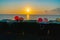 Boats and nautical gear silhouetted by rising sun