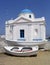 Boats next to seaside church, Mykonos, Greece