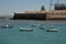 Boats off the coast of Cadiz near the fortress of Castillo Fortaleza de Santa Catalina.