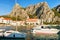 Boats and orthodox church at harbor in Cetina River Omis