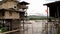 Boats passing by the stilted houses in the river