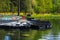 Boats on the pier in the city Park. Summer Park with a lake. Docked wooden rowing boat.