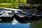 Boats on the pier in the city Park. Summer Park with a lake. Docked wooden rowing boat.