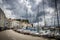 Boats in the Piran harbor under a threatening sky