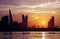 Boats in queue and Bahrain skyline at sunset