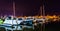 Boats reflecting in the water at night, in a marina on Kent Island