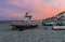 Boats at rest on the beach at Castell de Ferro, Spain as the sun sets