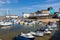 Boats resting on the sand at lowtide in the picturesque harbour and seaside town of Tenby in Wales