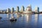 Boats riding on False Creek before the Science World museum under the blue sky in Vancouver