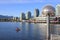 Boats riding on False Creek before the Science World museum under the blue sky in Vancouver