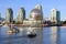 Boats riding on False Creek before the Science World museum under the blue sky in Vancouver