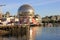 Boats riding on False Creek before the Science World museum under the blue sky in Vancouver