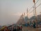 Boats at river Ganga Ghat people at holy ghats among ancient hindu temples in early morning in Varanasi Evening at Banaras Ghat