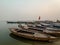 Boats at river Ganga Ghat people at holy ghats among ancient hindu temples in early morning in Varanasi Evening at Banaras Ghat