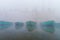 Boats on sacred river Ganges at cold foggy winter morning. Varanasi