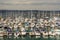 Boats and ships moored in a small port, in the background stone