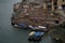 Boats and a small pedestrian bridge on the ghats of narmada river in the holy city of omkareshwar madhya pradesh India