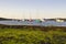 Boats on their moorings beside Cockle Island in the natural tidal harbour at Groomsport in Co Down,Northern Ireland with Belfast