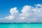 Boats in turquoise sea or ocean in grand turk, turks and caicos islands. Seascape with clear water on cloudy sky. Discovery, adven